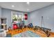 Bright bonus room with hardwood floors, a desk area, and plenty of space for exercise equipment and other activities at 6465 Lawrence Dr, Indianapolis, IN 46226