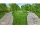 Long driveway lined with mature trees, providing privacy and a grand entrance to the property at 6465 Lawrence Dr, Indianapolis, IN 46226