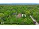 Aerial view of a secluded estate surrounded by lush greenery and mature trees at 6465 Lawrence Dr, Indianapolis, IN 46226