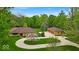 An impressive single story home with circle drive and three car detached garage on a landscaped lawn at 6465 Lawrence Dr, Indianapolis, IN 46226