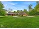 An impressive single story home with circle drive and three car detached garage on a landscaped lawn at 6465 Lawrence Dr, Indianapolis, IN 46226