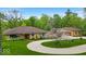 An impressive single story home with circle drive and three car detached garage on a landscaped lawn at 6465 Lawrence Dr, Indianapolis, IN 46226