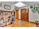 Foyer with hardwood floors, a wooden door, built-in bookshelves, and decorative accents at 6465 Lawrence Dr, Indianapolis, IN 46226