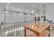 Spacious garage with concrete floors, work table, and two car garage doors on a well lit ceiling at 6465 Lawrence Dr, Indianapolis, IN 46226