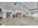 Large garage with an open layout, featuring concrete floors, shelving, and bright lighting at 6465 Lawrence Dr, Indianapolis, IN 46226