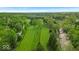 Scenic aerial view of lush green golf course with mature trees and distant skyline at 6465 Lawrence Dr, Indianapolis, IN 46226