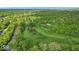 Aerial view of a golf course with a river and luxury homes surrounded by lush forest at 6465 Lawrence Dr, Indianapolis, IN 46226