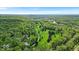 Picturesque aerial of a golf course and surrounding greenery with a lake in the distance at 6465 Lawrence Dr, Indianapolis, IN 46226