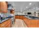 Gourmet kitchen featuring custom cabinets, granite countertops, mosaic backsplash, and stainless steel appliances at 6465 Lawrence Dr, Indianapolis, IN 46226