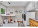 Well-equipped laundry room with front load washer and dryer, folding counter and storage at 6465 Lawrence Dr, Indianapolis, IN 46226