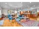 Open living room features hardwood floors, natural lighting, and views of a modern kitchen at 6465 Lawrence Dr, Indianapolis, IN 46226