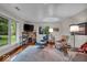 Bright living room featuring large windows, hardwood floors, a fireplace and stylish modern furnishings at 6465 Lawrence Dr, Indianapolis, IN 46226