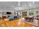 Open-concept living and dining area boasts hardwood floors, modern lighting, and a seamless flow at 6465 Lawrence Dr, Indianapolis, IN 46226