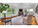 Bright living room featuring large windows, hardwood floors, a fireplace and stylish modern furnishings at 6465 Lawrence Dr, Indianapolis, IN 46226