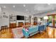 Bright living room featuring hardwood floors, a vibrant blue sofa, and stylish mid-century modern furniture at 6465 Lawrence Dr, Indianapolis, IN 46226