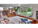 Bright living room featuring large windows, hardwood floors, a fireplace and stylish modern furnishings at 6465 Lawrence Dr, Indianapolis, IN 46226
