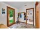 Mudroom with slate tile floors, a coat rack, and a view of the exterior through a glass door at 6465 Lawrence Dr, Indianapolis, IN 46226