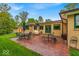 Outdoor patio with brick pavers, seating and dining areas, and view of manicured lawn at 6465 Lawrence Dr, Indianapolis, IN 46226