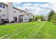 Large backyard with lush grass, featuring a patio for leisure, and providing ample space for entertainment and outdoor enjoyment at 7045 Gavin Dr, Indianapolis, IN 46217