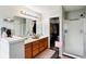 Bathroom with double sinks, a glass enclosed shower and a walk-in closet ensuring a convenient and luxurious experience at 7045 Gavin Dr, Indianapolis, IN 46217
