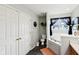 Full bathroom offering a toilet, a bathtub with curtains and double door storage with tiled floors at 7045 Gavin Dr, Indianapolis, IN 46217