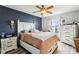 Primary bedroom with accent wall, ceiling fan and large window at 7045 Gavin Dr, Indianapolis, IN 46217
