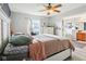 Bright bedroom featuring a ceiling fan, a window and an ensuite bathroom, creating a serene and comfortable retreat at 7045 Gavin Dr, Indianapolis, IN 46217