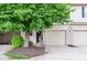 Charming townhouse featuring a one-car garage, lovely landscaping, and cozy front porch at 7045 Gavin Dr, Indianapolis, IN 46217