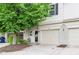 Charming townhouse featuring a one-car garage, lovely landscaping, and cozy front porch at 7045 Gavin Dr, Indianapolis, IN 46217