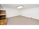 An open finished room in basement features neutral carpet and a built-in shelf at 7245 Highburry Dr, Indianapolis, IN 46256