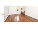 Bedroom featuring hardwood floors, a window, a wooden chair, and a red lamp at 7245 Highburry Dr, Indianapolis, IN 46256