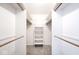 Walk-in closet with carpeted floor, shelving, and wooden rods for ample storage at 7245 Highburry Dr, Indianapolis, IN 46256