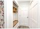 Bright entryway with a wooden bench, coat hooks, and storage shelves at 7245 Highburry Dr, Indianapolis, IN 46256