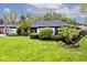 Well-maintained front yard with lush green grass, and an attached garage at 7245 Highburry Dr, Indianapolis, IN 46256