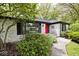 Bright white brick home with black trim and a vibrant red front door at 7245 Highburry Dr, Indianapolis, IN 46256
