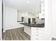 Bright kitchen features white cabinets, granite countertops, and breakfast bar at 7245 Highburry Dr, Indianapolis, IN 46256
