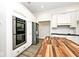 Bright kitchen with white cabinets, stainless steel appliances, double oven, and a wooden island at 7245 Highburry Dr, Indianapolis, IN 46256