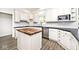 Updated kitchen with white cabinets, stainless steel appliances, black countertop, and center island at 7245 Highburry Dr, Indianapolis, IN 46256