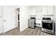 Laundry room featuring a washer, dryer, and overhead cabinets at 7245 Highburry Dr, Indianapolis, IN 46256