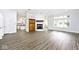 Open-concept living room with modern flooring, fireplace, and open view of kitchen at 7245 Highburry Dr, Indianapolis, IN 46256