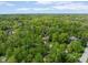 Aerial view of wooded property showcasing a home nestled among lush greenery at 7420 Denton Cir, Indianapolis, IN 46256