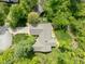 An aerial view captures a home with a beautiful backyard and patio in a lush wooded area at 7420 Denton Cir, Indianapolis, IN 46256