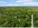 Aerial view of a wooded property showcasing a home nestled among lush greenery at 7420 Denton Cir, Indianapolis, IN 46256