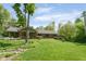 Expansive backyard featuring a brick home, hammock and lush green lawn, perfect for outdoor enjoyment at 7420 Denton Cir, Indianapolis, IN 46256