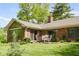 The backyard patio features a dining table set on a lush green lawn, perfect for outdoor gatherings at 7420 Denton Cir, Indianapolis, IN 46256