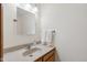 Cozy powder room features a granite sink, framed mirror, and neutral decor at 7420 Denton Cir, Indianapolis, IN 46256