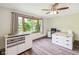 Bright bedroom features a large window, neutral walls, and modern ceiling fan at 7420 Denton Cir, Indianapolis, IN 46256