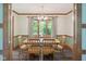 Bright dining room showcasing a wooden table, seating for six, and view to yard at 7420 Denton Cir, Indianapolis, IN 46256