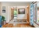 Bright foyer showcasing tile flooring, fresh paint, a charming front door, and seamless flow to other living spaces at 7420 Denton Cir, Indianapolis, IN 46256