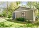 Charming exterior view of home with siding, a blue door, and small garden at 7420 Denton Cir, Indianapolis, IN 46256